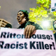 A protester holds a sign during a demonstration Friday, Nov. 19, 2021, in Oakland, Calif., following the acquittal of Kyle Rittenhouse in Kenosha, Wis.